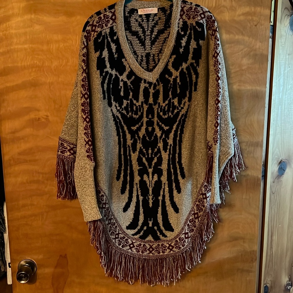 Beautiful sleeved poncho. Like new, only worn once. Nice and warm!